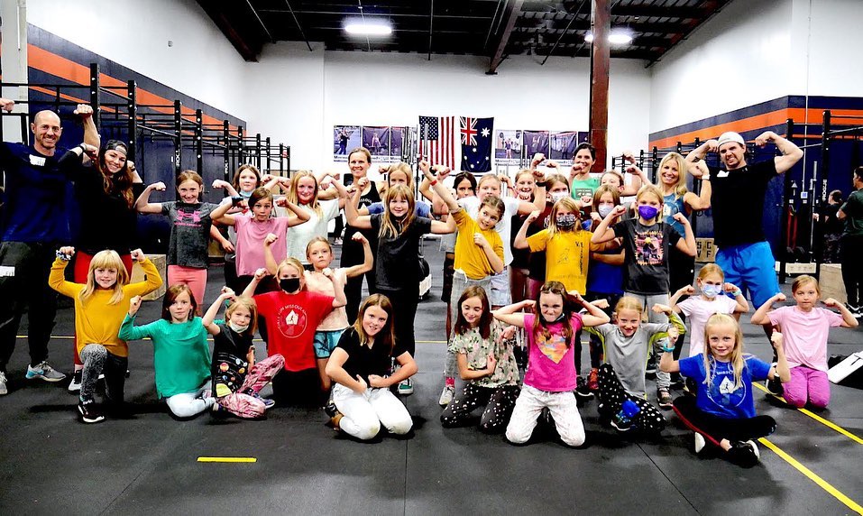 Group of girls posing in a gym at a kids strength training program in Missoula